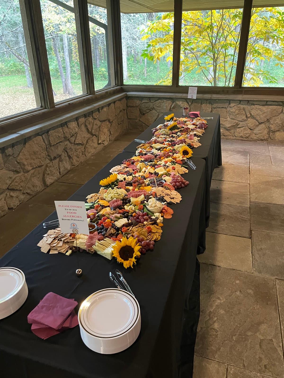A catering prep table with food and service details.